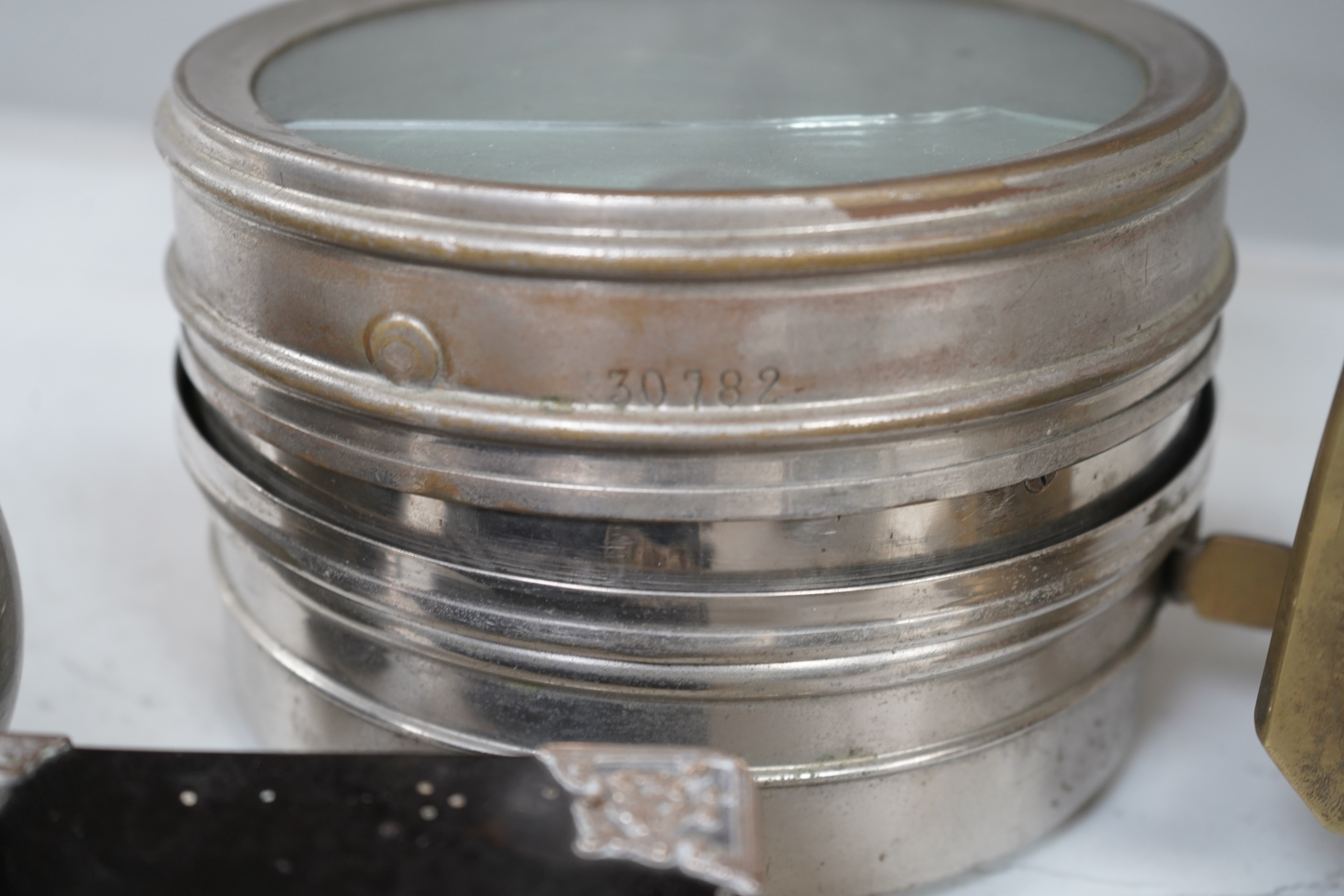 A small collection of metalware to include a white metal mounted tortoiseshell box, brass cased carriage clock with subsidiary dial and a pewter tankard. Condition - poor to fair